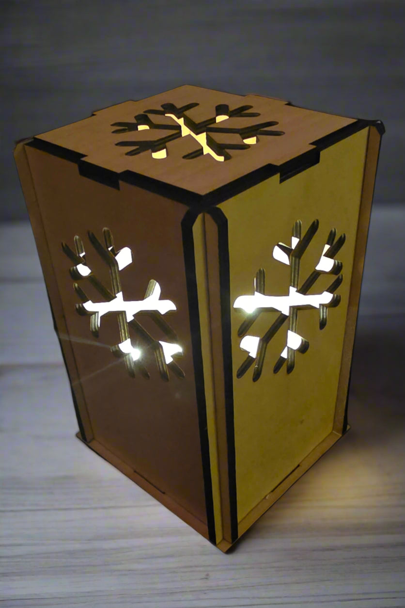 6 sided wooden lantern with snowflake cutouts to allow light to shine through